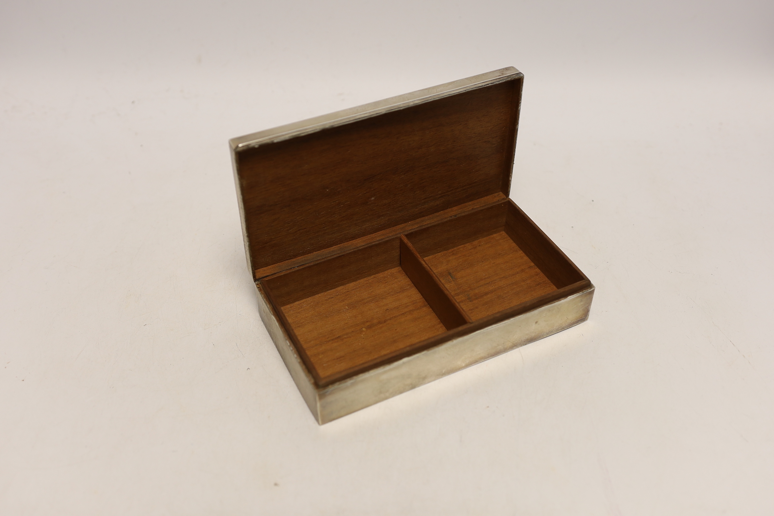 A sterling 925 mounted rectangular cigarette box, with reeded cover, 17.4cm and a similar unmarked cigarette lighter.